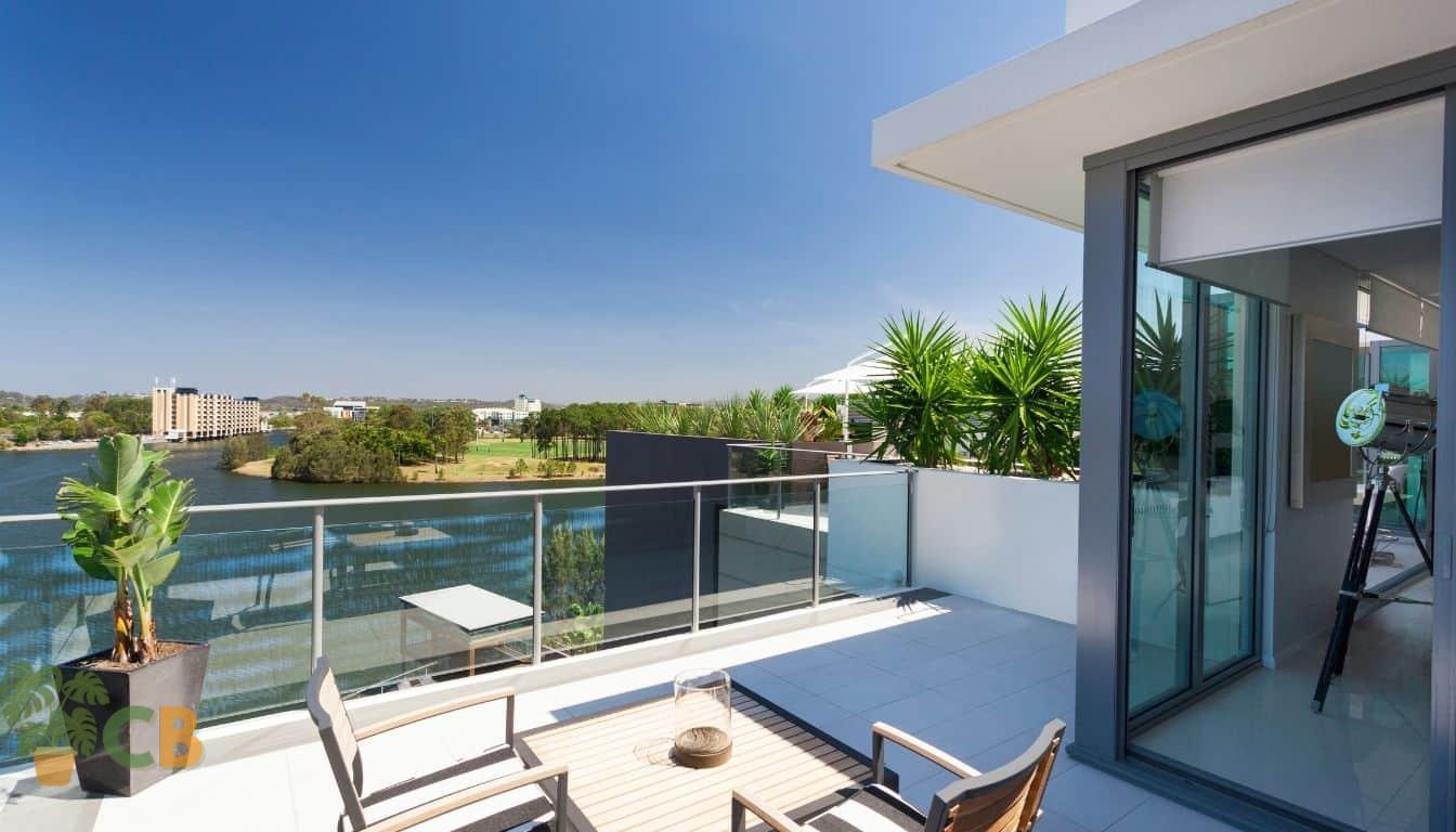 Apartment balcony patio with stone tiles overlooking a river
